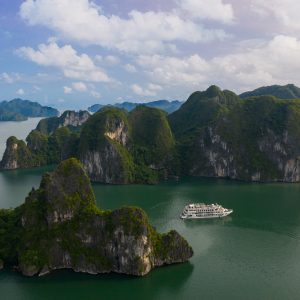 A luxury cruise sailing through the limestone karsts of Halong Bay, a UNESCO World Heritage Site