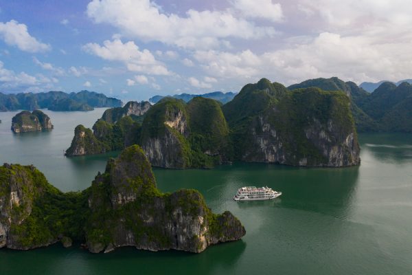 A luxury cruise sailing through the limestone karsts of Halong Bay, a UNESCO World Heritage Site