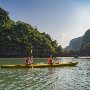 Tourists kayaking in Vung Vieng Fishing Village during Ha Long Bay 2-day cruise