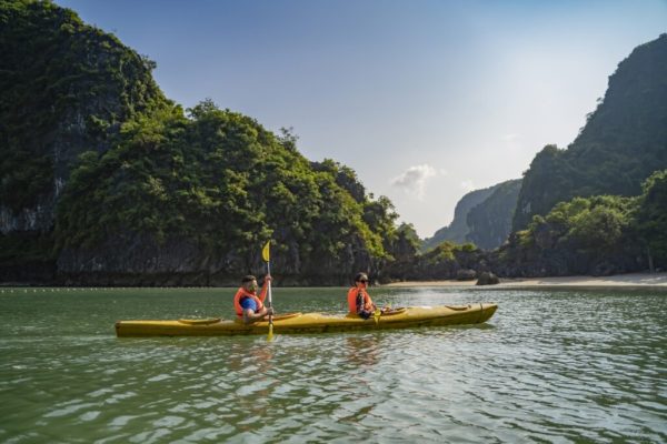 Tourists kayaking in Vung Vieng Fishing Village during Ha Long Bay 2-day cruise