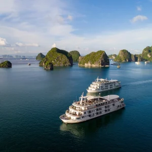 A luxury cruise sailing through the limestone karsts of Halong Bay, a UNESCO World Heritage Site