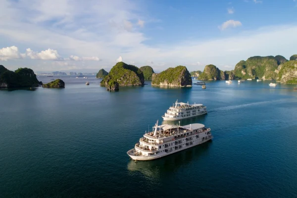 A luxury cruise sailing through the limestone karsts of Halong Bay, a UNESCO World Heritage Site