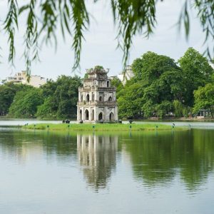 Scenic Hoan Kiem Lake in the heart of Hanoi, featuring the iconic Turtle Tower and The Huc Bridge leading to Ngoc Son Temple