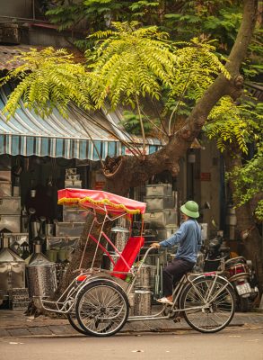 A traditional cyclo in Hanoi Old Quarter, offering tourists an authentic experience of Vietnam’s bustling streets and historic sites