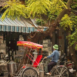 A traditional cyclo in Hanoi Old Quarter, offering tourists an authentic experience of Vietnam’s bustling streets and historic sites