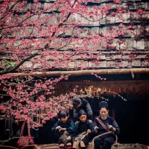 Local ethnic minority people in Sapa showcasing vibrant traditional clothing and handicrafts